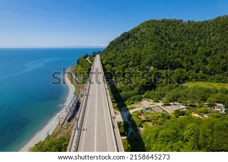 The Zubova Schel Viaduct is a road bridge, Dzhubga - Adler federal road. Aerial view of car driving along the winding mountain road in Sochi, Russia. Royalty-Free Stock Photo #2158645273