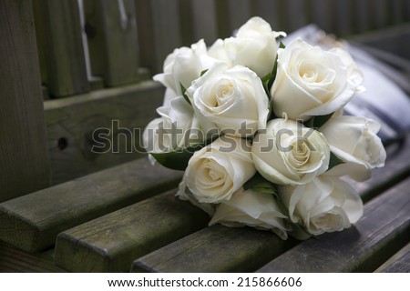 Wedding roses bouquet on wooden bench