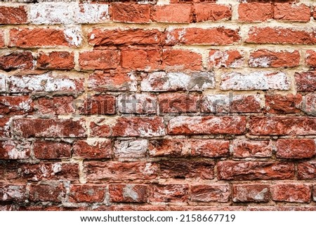 Old brick wall. Grunge background. Dark red old brick wall background eroded by time and natural brick texture.