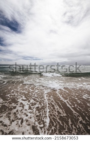 The view of a sea waves making foam and mixing with the sky
