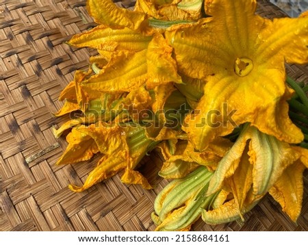 yellow pumpkin flower In bamboo baskets, vegetables and herbs are used to cook boiled food or eat with chili paste.