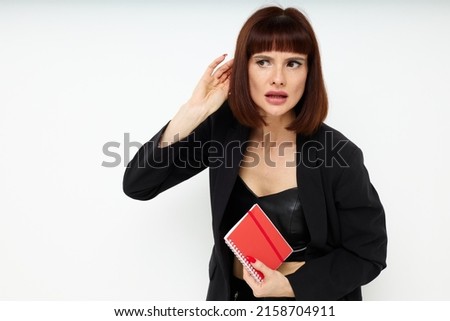 photo pretty woman in a black jacket notepad writing ideas light background