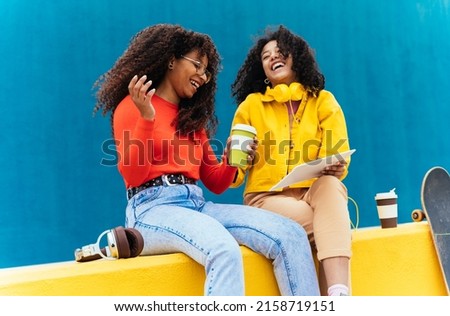 Young happy women studying on a tablet device. teenagers spending time together after school Royalty-Free Stock Photo #2158719151