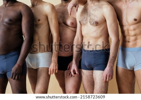 group of multiethnic men posing for a male edition body positive beauty set. Shirtless guys with different age, and body wearing boxers underwear Royalty-Free Stock Photo #2158723609