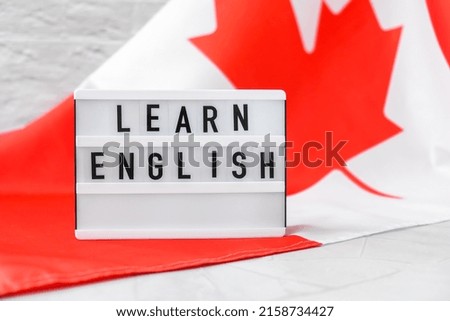 The National Flag of Canada. Lightbox with text LEARN ENGLISH Canadian Flag or the Maple Leaf. Patriotism. International relations concept. Independence day. Immigration