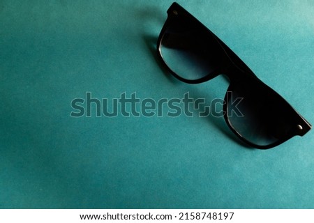 black sunglasses on a blue background