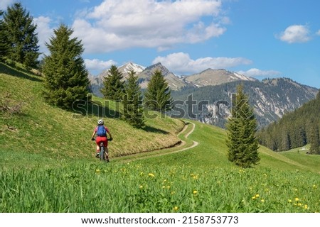 nice senior woman riding her electric mountain bike in the Lech Valley mountains near Reutte in Tirol, Austria Royalty-Free Stock Photo #2158753773