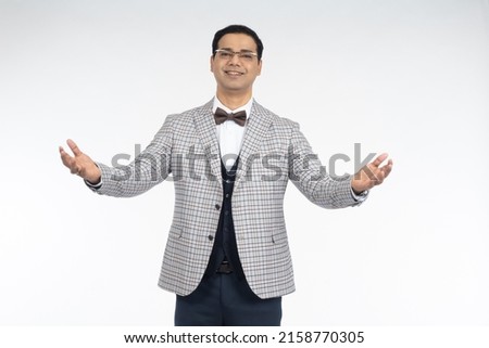 Brunette man looks at camera. Guy with eyeglasses. Brunette man smiles with his arms outstretched. Man model posing on studio isolated on white. Successful cheerful male. Portrait of male brunette. Royalty-Free Stock Photo #2158770305
