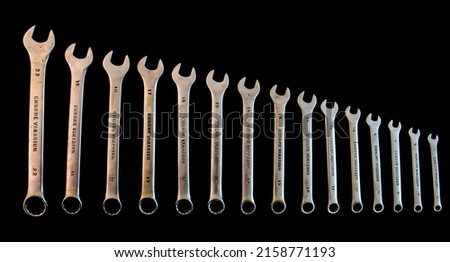 Old set of open-end wrenches isolated on black.