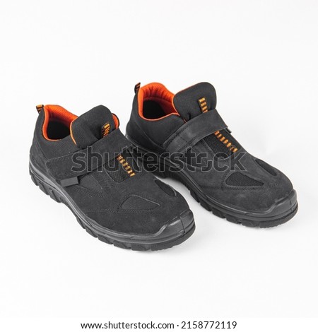 Safety leather shoes isolated on white background. Work shoes for men in factory or industry to protect feet from accident. Safety shoes. Oil and acid resistant shoes. Royalty-Free Stock Photo #2158772119