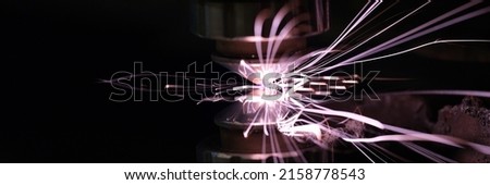 Sparks from metal on a dark background, close-up