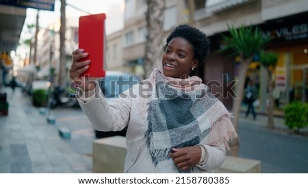 Young african american woman smiling confident having video call at street