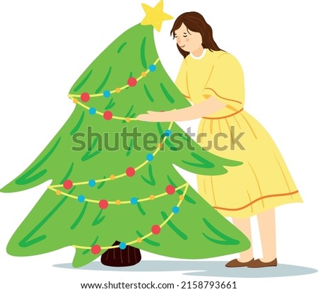 Happy cute girl at the Christmas tree. Making wishes for the New Year. Family celebration of the New Year concept