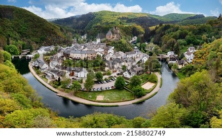 Aerial view of Esch-sur-Sure, medieval town in Luxembourg, dominated by castle, canton Wiltz in Diekirch. Forests of Upper-Sure Nature Park, meander of winding river Sauer, near Upper Sauer Lake. Royalty-Free Stock Photo #2158802749