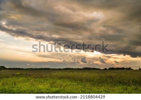 Cloudy sunset landscape in a countryside field