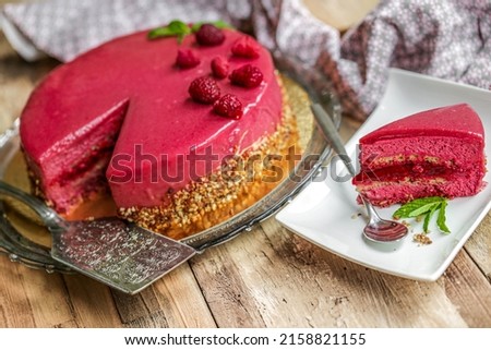 delicious rasberry entremet on wooden backbround