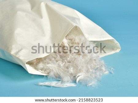 Pillow made of natural feathers. The pillow is stuffed with bird feathers Royalty-Free Stock Photo #2158823523