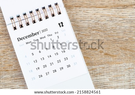 The December 2022 desk calendar on wooden background. Royalty-Free Stock Photo #2158824561