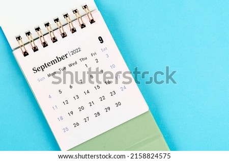 The September desk calendar 2022 on blue background. Royalty-Free Stock Photo #2158824575