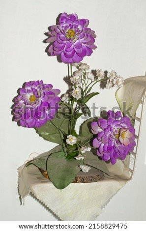 A bouquet of flowers with purple-purple buds.View on a white background.