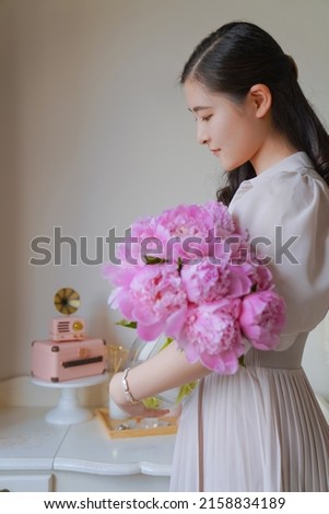 A Girl and pink peony flower