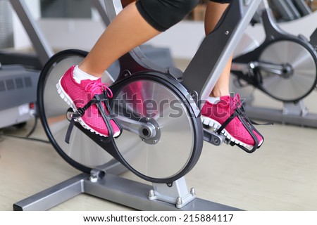 Exercise bike with spinning wheels.  Royalty-Free Stock Photo #215884117