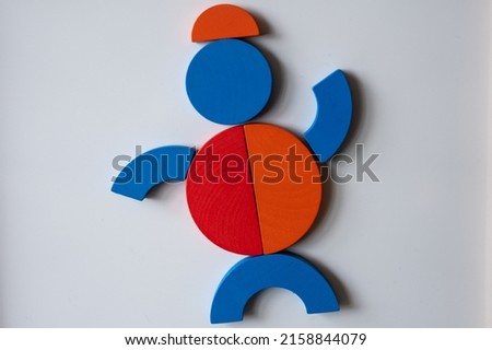 A top view of a man in a form of colorful geometric shapes on a grey background