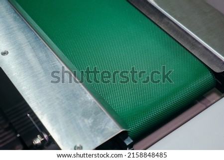 PVC conveyor belts are used for conveying lightweight materials such as conveying in the food industry. Royalty-Free Stock Photo #2158848485