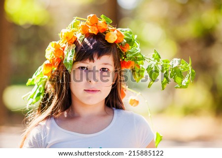 Portrait of little girl in autumn park with yellow foliage