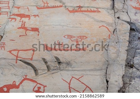 Prehistoric petroglyphs red graffiti in Alta, Norway