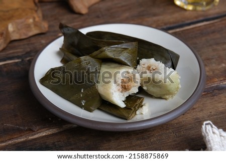 Buras Oncom.  Traditional food from West Java.  Rice cake with oncom filling, wrapped in banana leaf.  Food for breakfast with fritters Royalty-Free Stock Photo #2158875869
