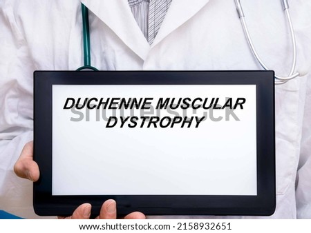 Duchenne Muscular Dystrophy.  Doctor with rare or orphan disease text on tablet screen Duchenne Muscular Dystrophy Royalty-Free Stock Photo #2158932651