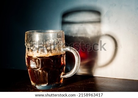 Red cherry beer in a mug and its shadow Royalty-Free Stock Photo #2158963417