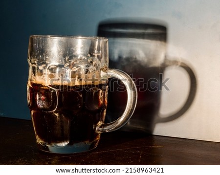 Red cherry beer in a mug and its shadow Royalty-Free Stock Photo #2158963421