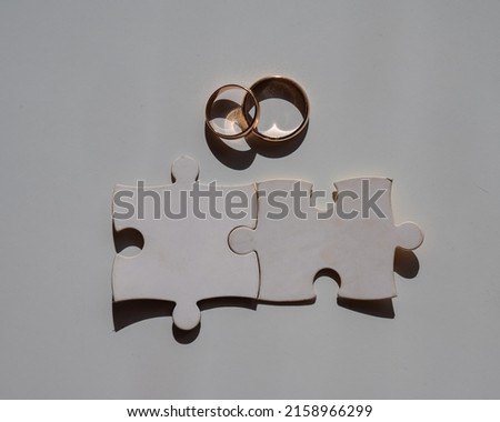 Wedding rings and puzzle pieces. Husband and wife complement each other perfectly.