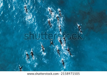 Triathlete swimmers during competition. Overhead view Royalty-Free Stock Photo #2158971505