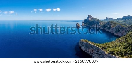 Panoramic view of beautiful Mediterranean seascape. Scenic Rocky cliffs on seaside against sky. Idyllic blue ocean at island in summer. Royalty-Free Stock Photo #2158978899