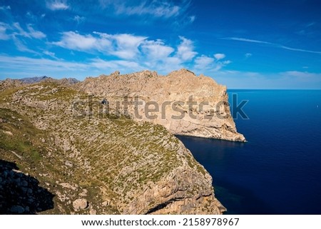 High angle view of Mediterranean seascape. Idyllic view of rocky cliff on seaside during sunny day. Scenic blue ocean at beautiful island in summer.