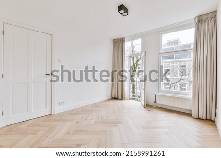 Plastic window and radiator on white wall in empty light room at home