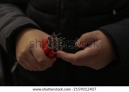 Young kid Holding Dangerous Red Petards Royalty-Free Stock Photo #2159012407