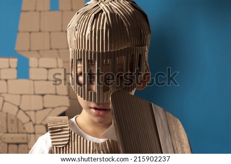 photo of the boy in medieval knight costume made of cardboards. this decorations are made specially for this photosession by me.