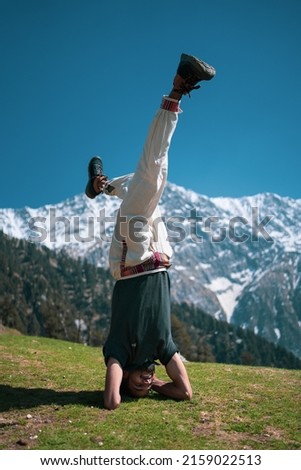 Happy person doing yoga in mountain, Triund Trek, Himachal Pradesh, India. Royalty-Free Stock Photo #2159022513