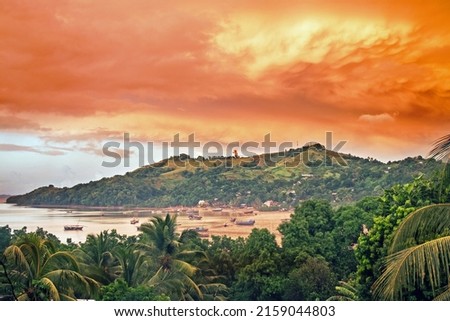 Early morning view over a bay near Hell Ville on Nosy Be, Northern Madagdascar after a tropical storm  Ships lie on the beach at low tide  Royalty-Free Stock Photo #2159044803