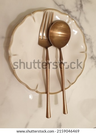 White Empty Plate with Copper Fork and Spoon