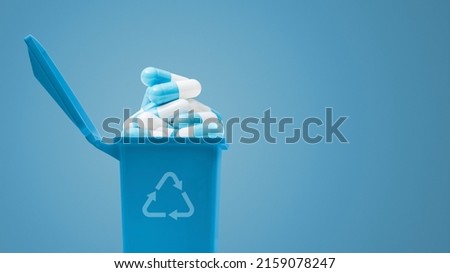 Open garbage can full of pills, medical waste concept Royalty-Free Stock Photo #2159078247