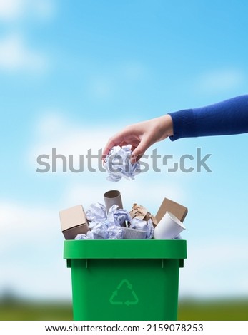 Woman putting paper in the waste bin, separate waste collection and recycling concept Royalty-Free Stock Photo #2159078253