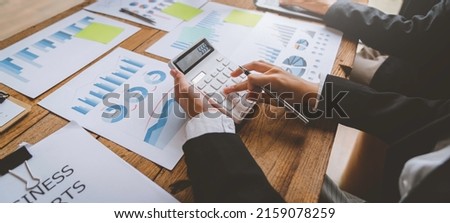 Close up business adviser partnership coworkers using a tablet to chart company financial statements report and profits work progress and brainstorming, discussing and analyzing business strategy. Royalty-Free Stock Photo #2159078259