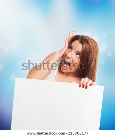 young pretty woman holding a banner surprised