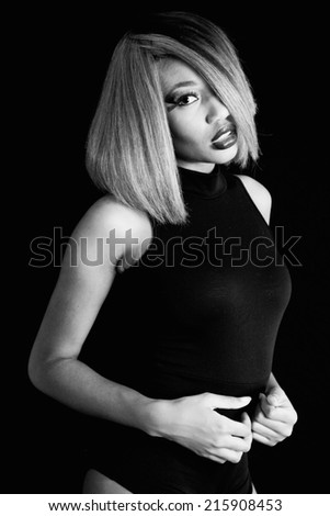 Black woman in black and white, looking at the camera with a thoughtful expression