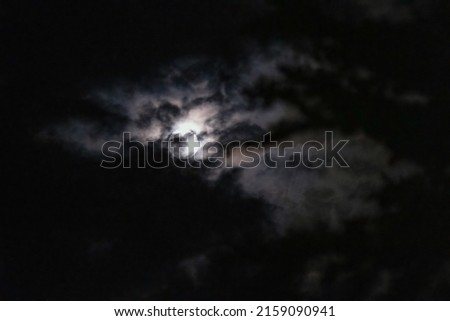 Full moon behind dark clouds sky replacement